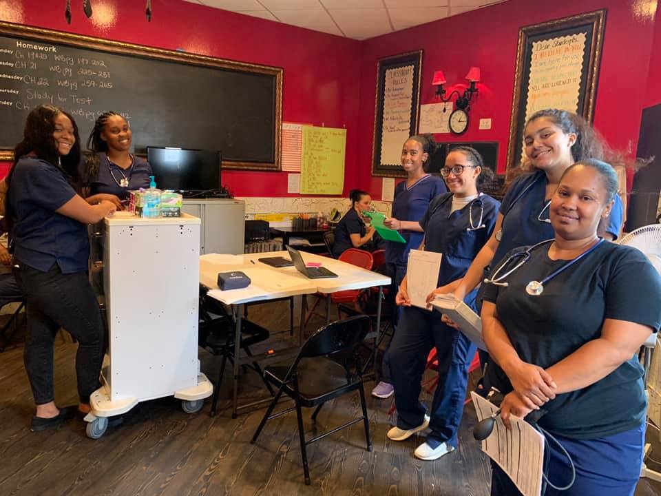 A Group Of Individuals Standing In A Training Center