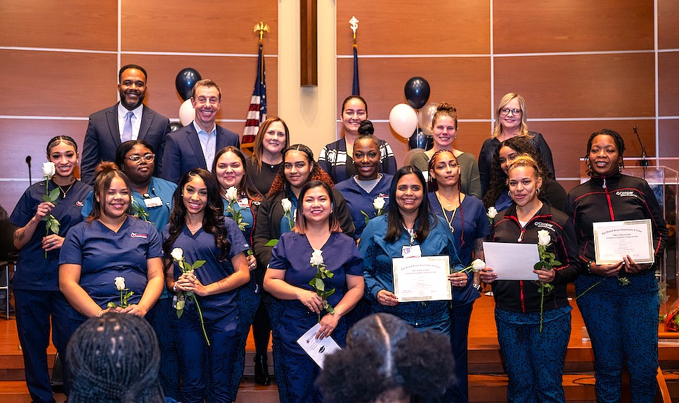 Several People Seated In A Meeting Space